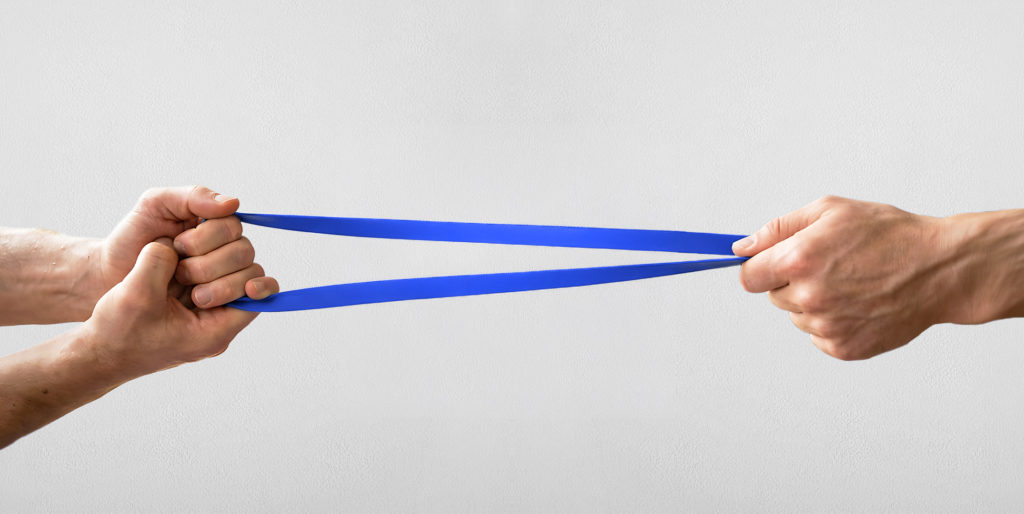 Hands pulling elastic band.