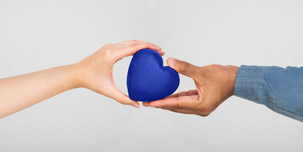 Two hands holding a heart