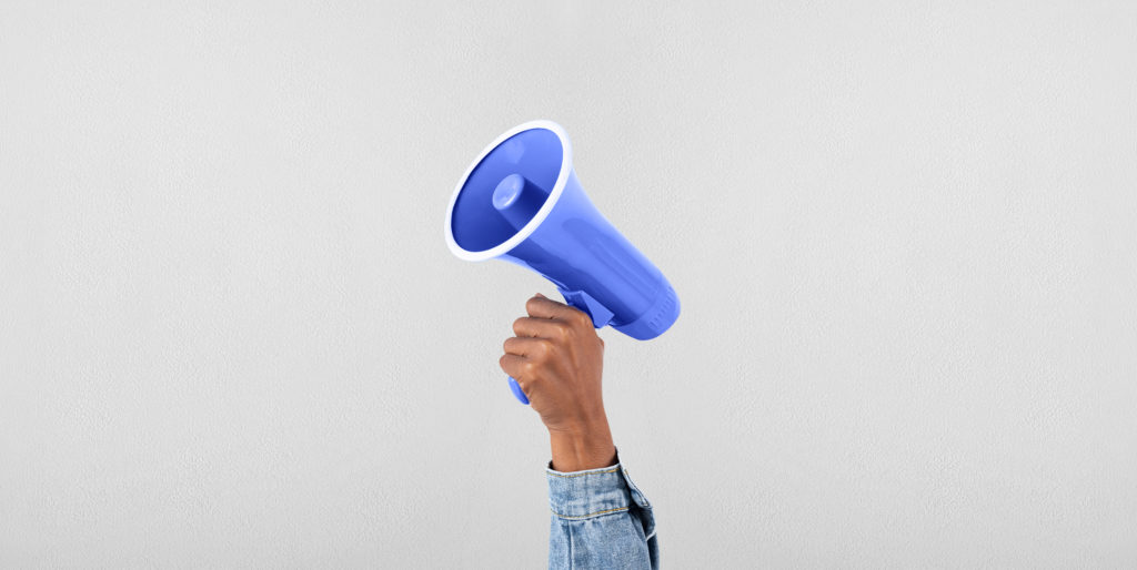 Hand holding a megaphone