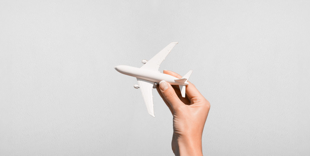 Hand holding a toy aeroplane