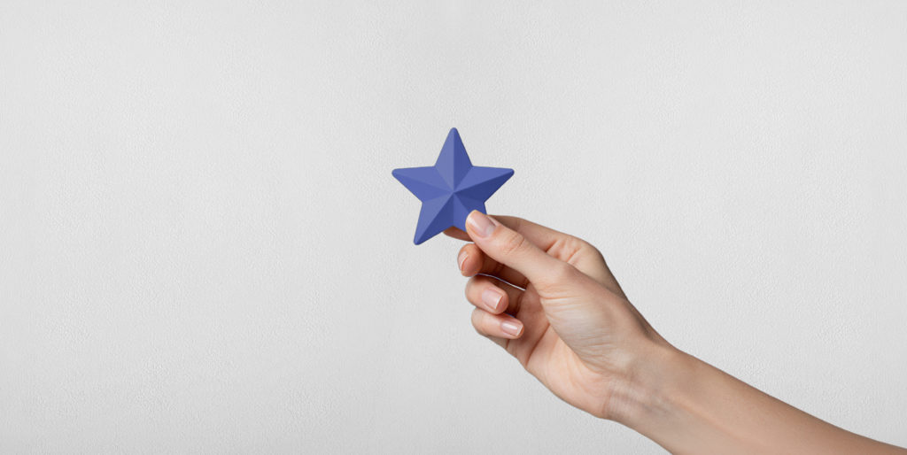 Hand holding blue star.
